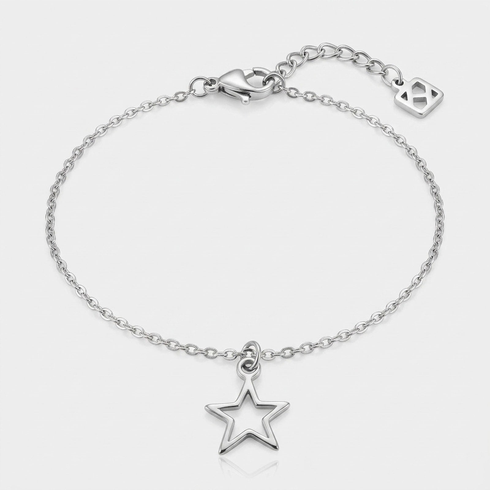 A single silver hollow star charm bracelet on a anchor chain