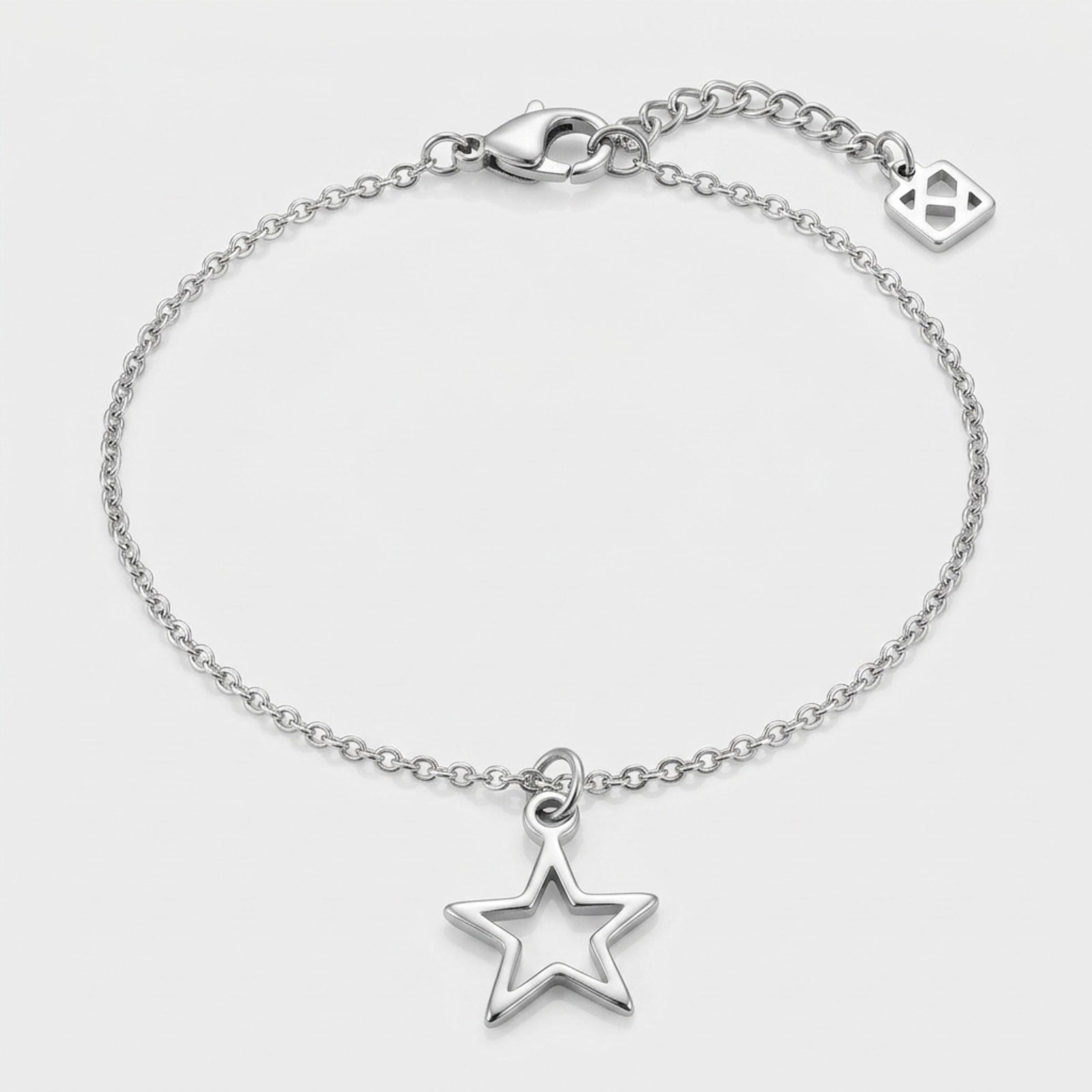 A single silver hollow star charm bracelet on a belcher chain