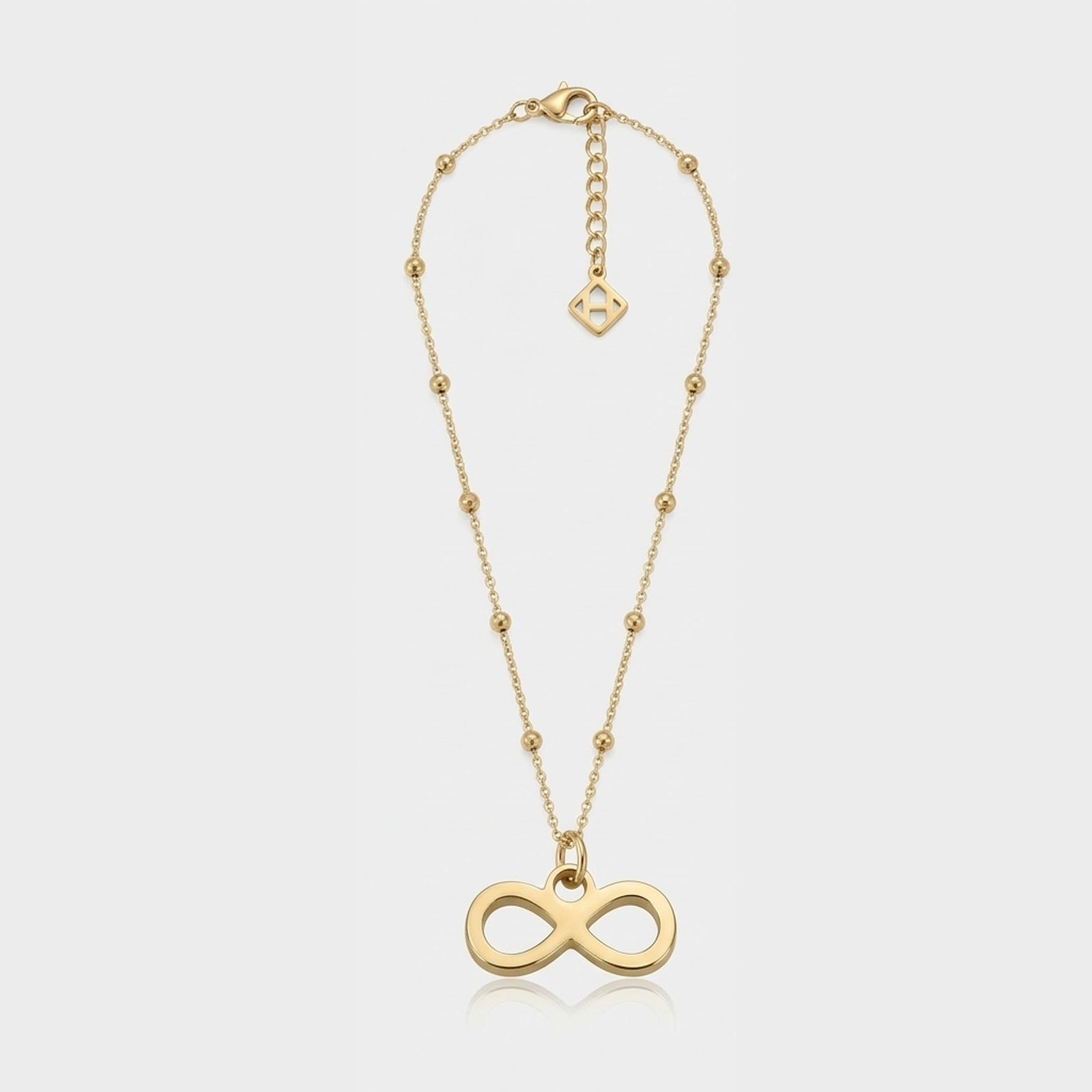 A single gold infinity charm necklace on a satellite chain, the charm hanging from a round jump ring through its own loop