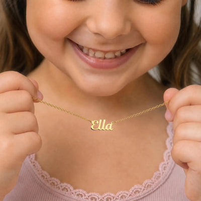 Child holding gold Ella name necklace